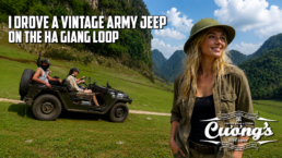 Smiling woman in a green hat stands in a grassy valley with a vintage US Army jeep and rugged mountains in the background, suggesting a Ha Giang Loop adventure.