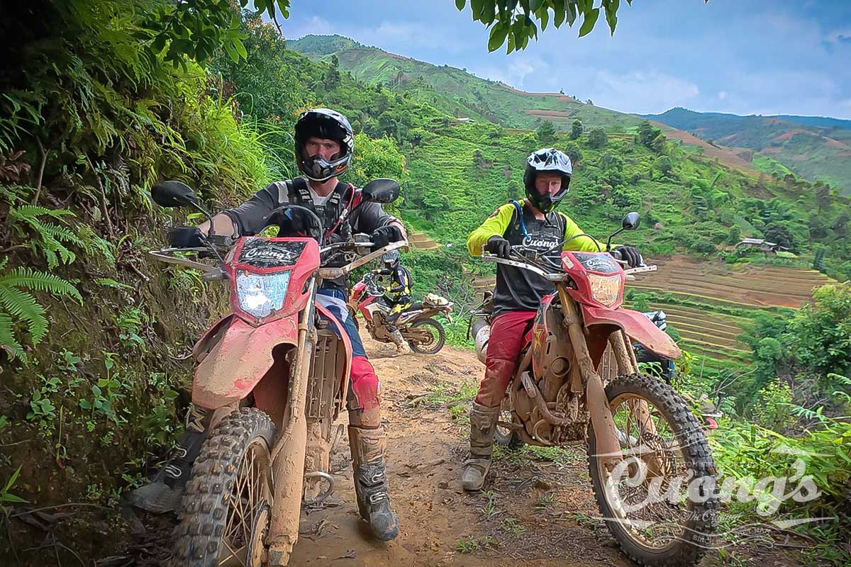 Riders on Honda CRF 300L crossing a river on the Northwest Vietnam Off-Road Tour with Cuong's Motorbike Adventure